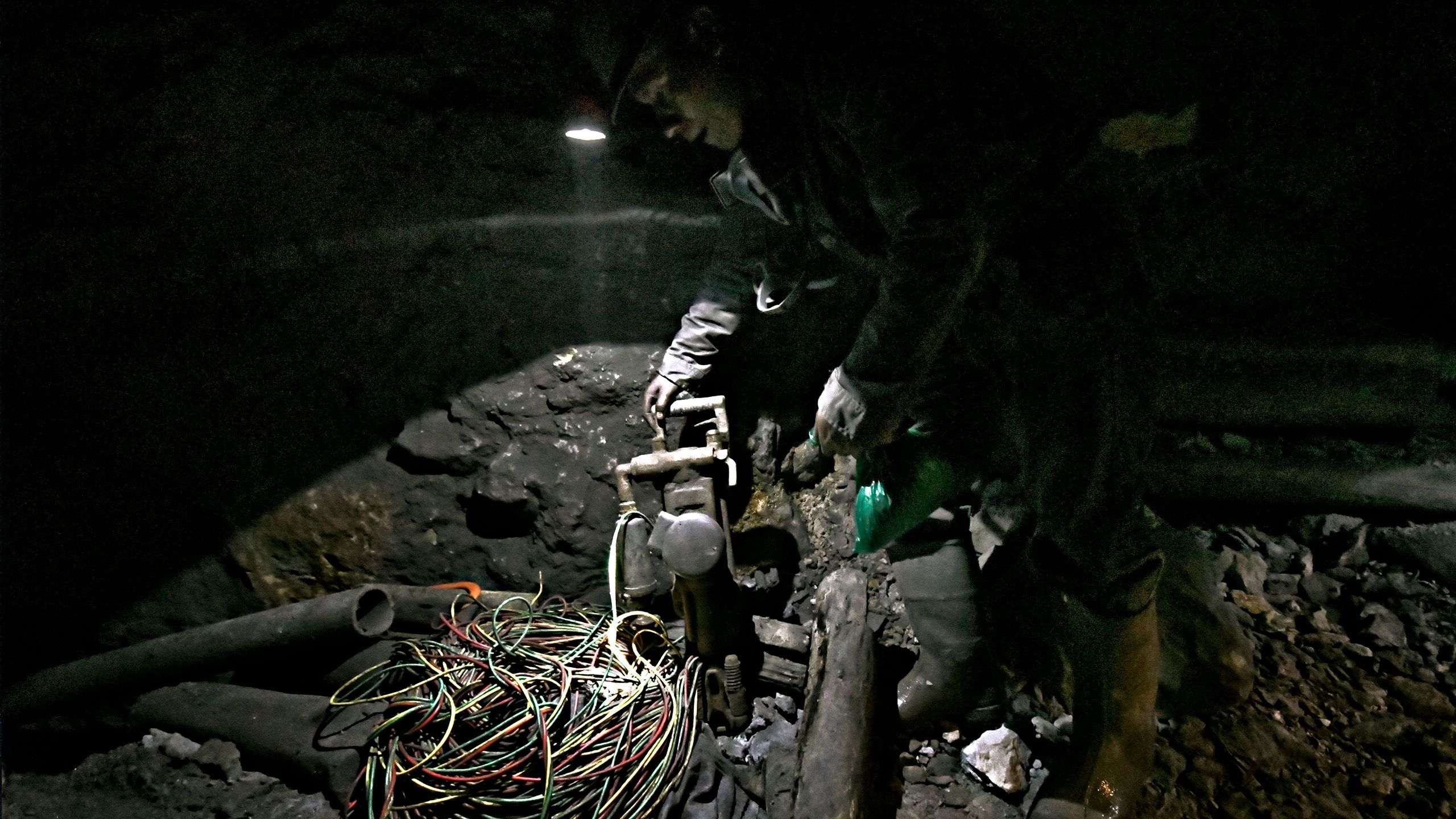 Worker holding a pneumatic hammer.